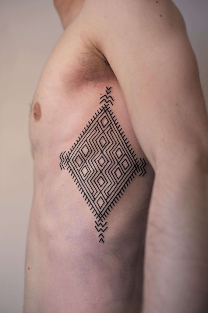 Black Geometric Ornament Tattoo On The Side