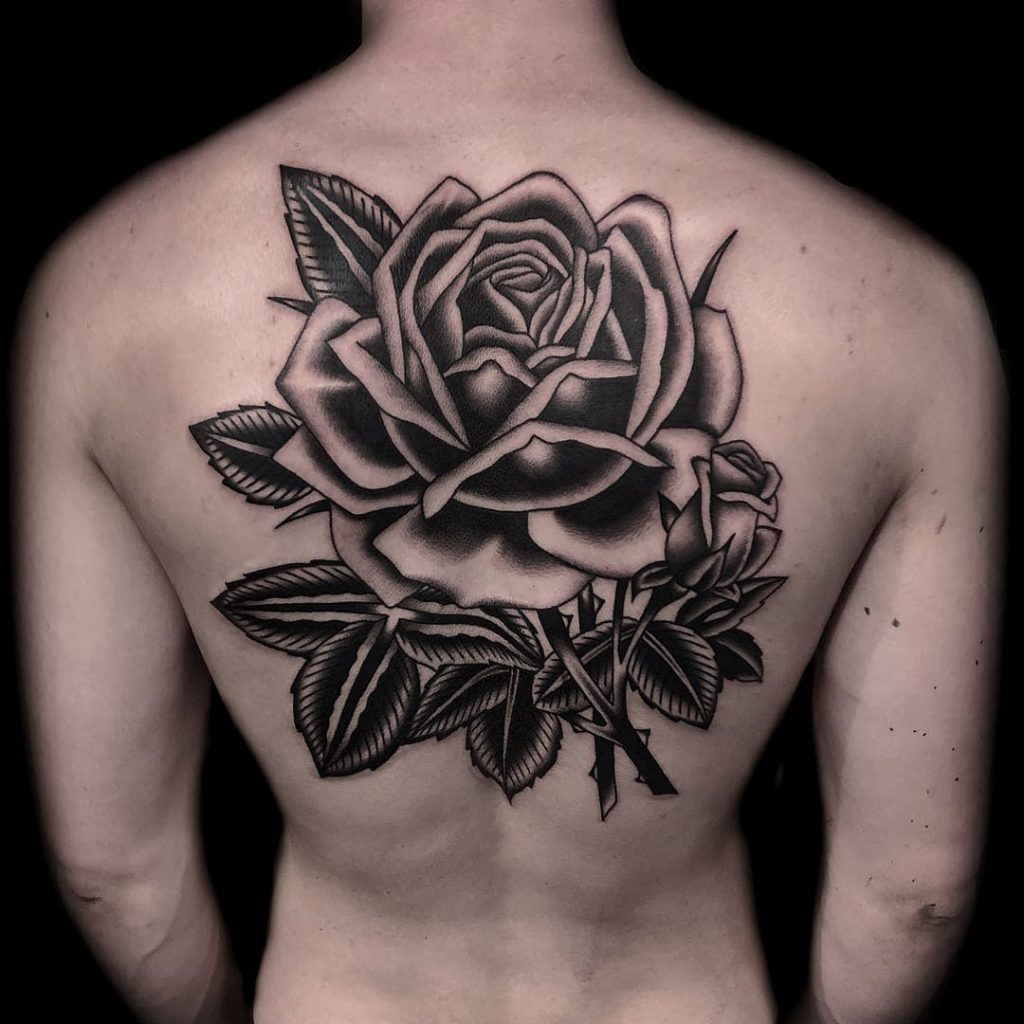 Black rose tattoo on the neck