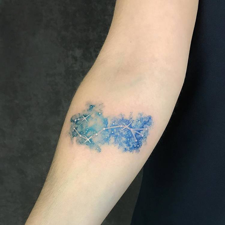 Blue ink scorpio constellation tattoo