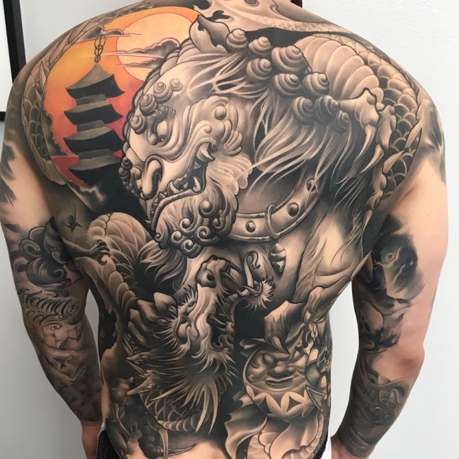 Foodog and dragon men back tattoo