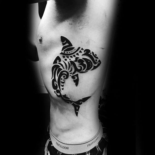 Amazing guys tattoo of tribal hawaiian shark on side of ribs