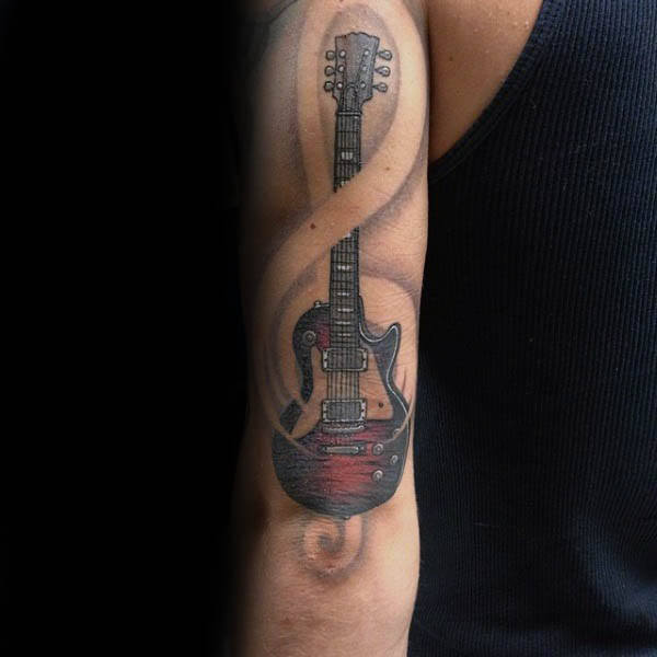 Amazing treble clef guitar mens arm tattoo