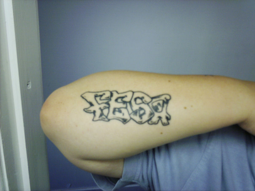 Awesome grey ink graffiti tattoo on right sleeve