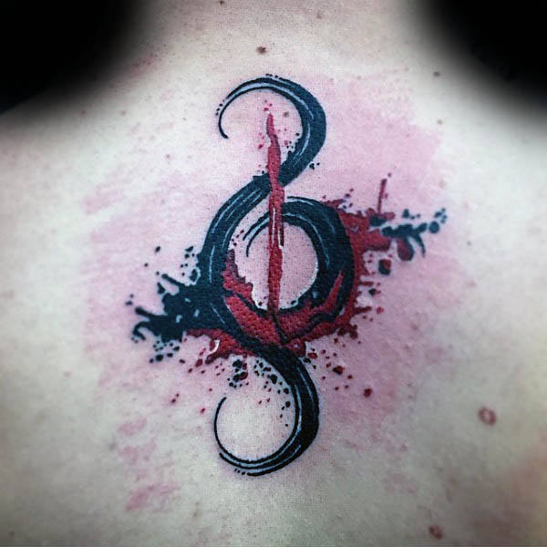 Black and red treble clef watercolor upper back tattoo on man