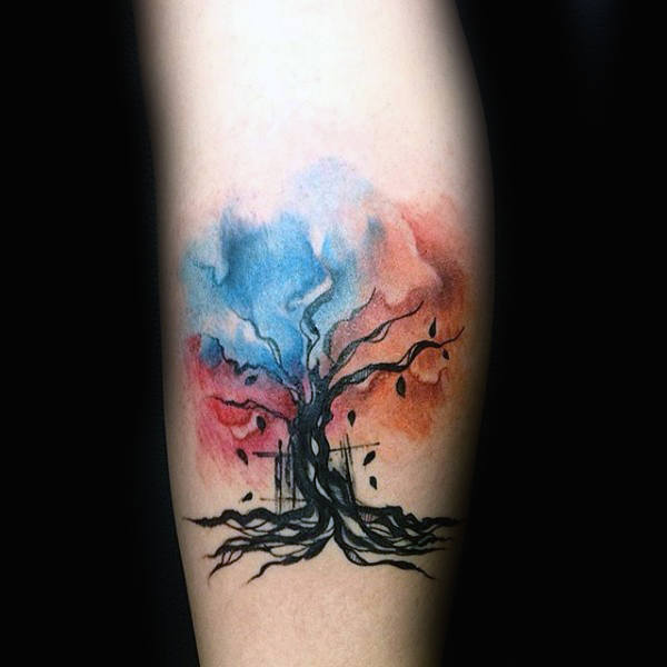 Black leaves falling out of watercolor tree tattoo male forearms