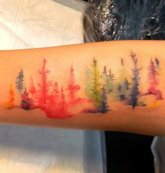 Blurred watercolor trees tattoo male forearms