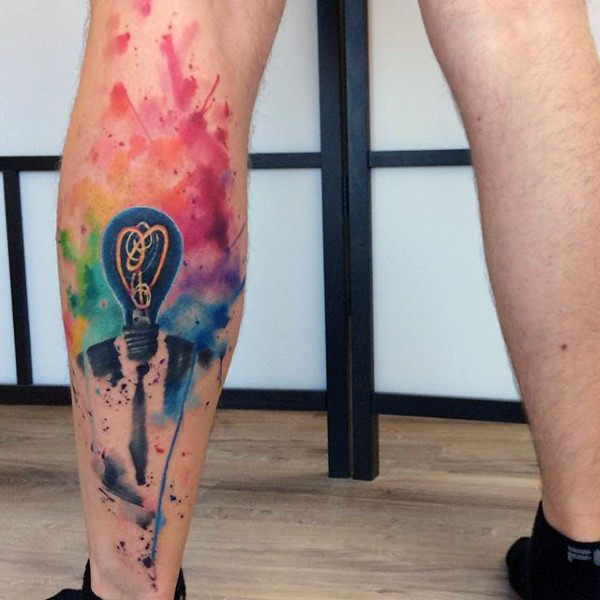 Bright male watercolor tattoo on calves