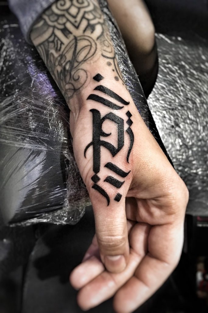 Calligraphy hand men tattoo