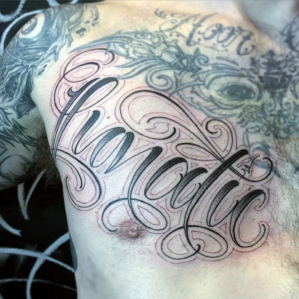 Chest tattoo of lunatic word script design