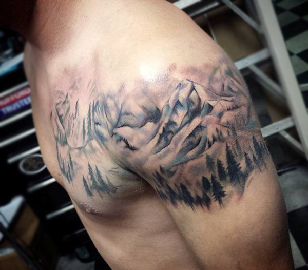 Classical shoulder tattoo alpine forest under mountains