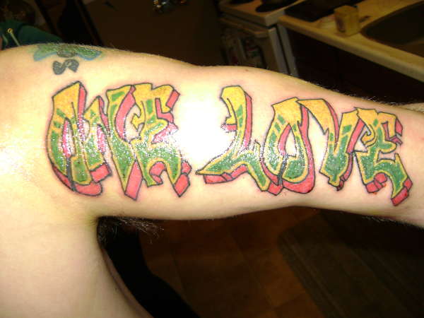 Colored graffiti tattoo on right sleeve