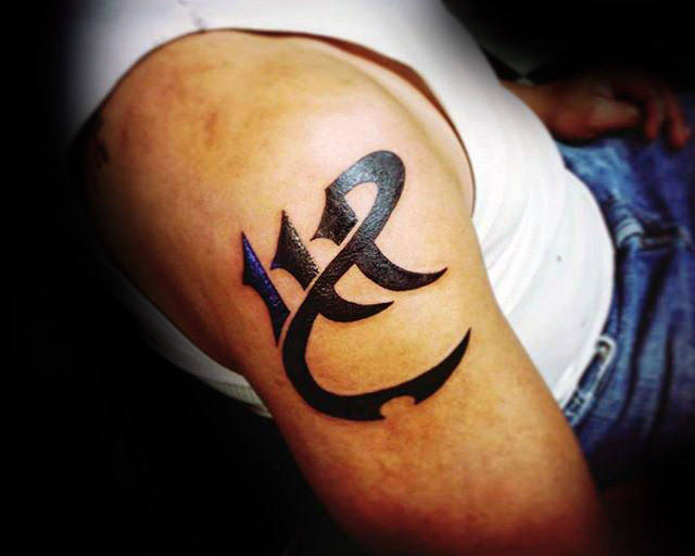 Cool black ink virgo mens tribal upper arm tattoo
