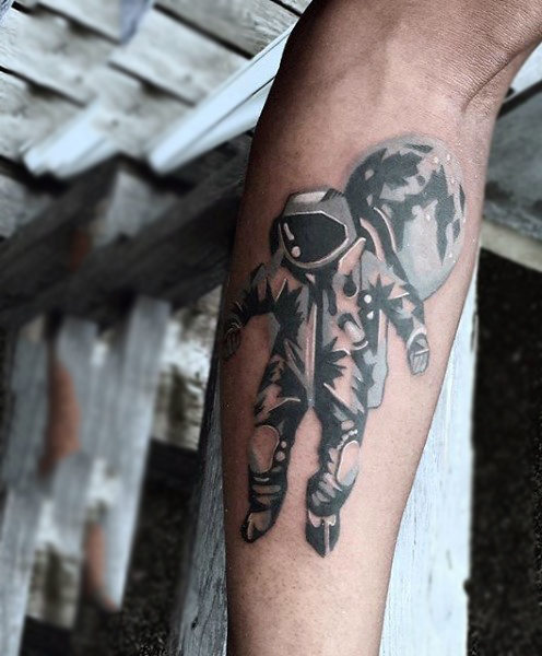 Cool floating astronaut tattoo on forearm