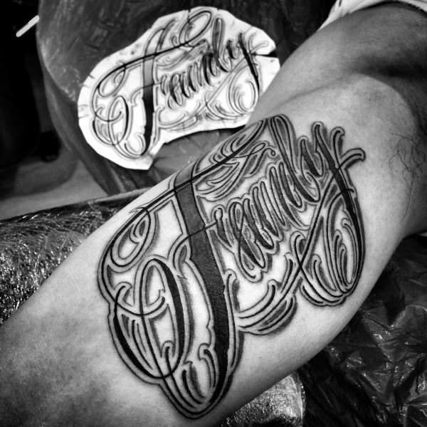 Cool guys ornate script family tattoo on inner bicep of arm