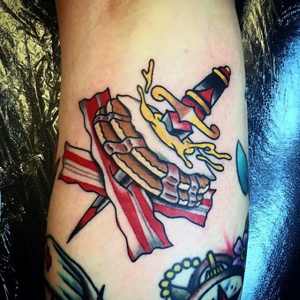 Cream donut and dagger tattoo male forearm