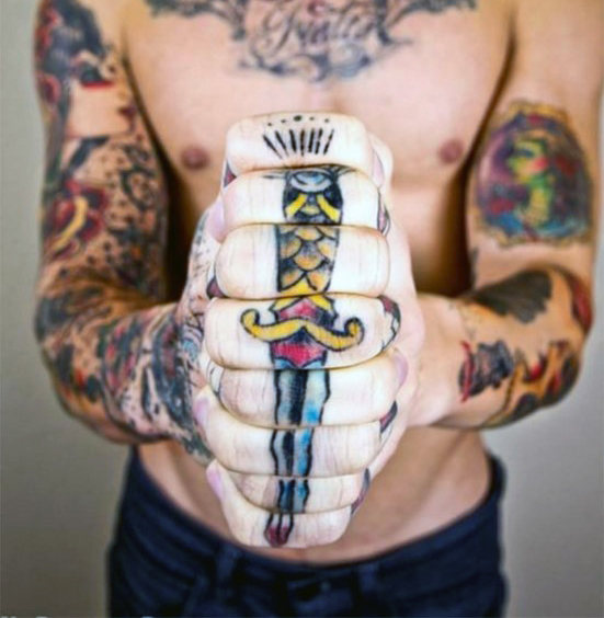 Dagger hand torso tattoo for males