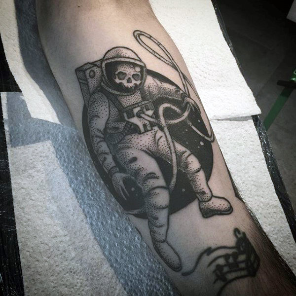 Dotted black astronaut tattoo mens forearm