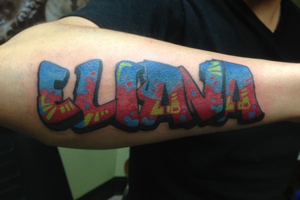 Elana graffiti tattoo on right arm