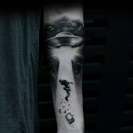 Floating man with ufo spaceship guys inner forearm tattoo
