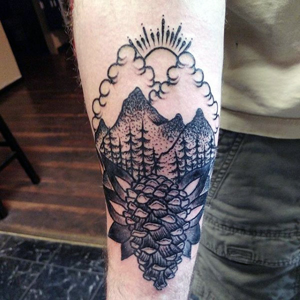 Forearm black ink tattoo pine cone and sun behind mountains