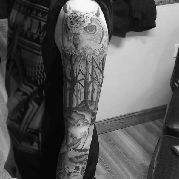 Full sleeve black ink tattoo owl head overlooking dead forest on gentleman