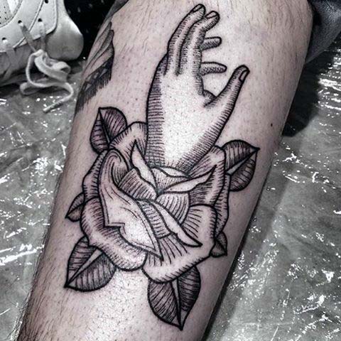 Gentleman with woodcut hand and rose flower leg tattoo