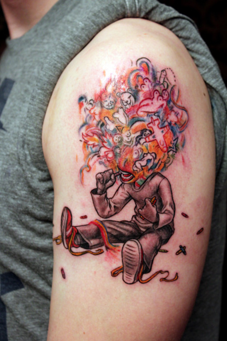 Graffiti tattoo on man left shoulder
