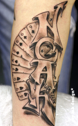 Grey ink cards and graffiti tattoo on sleeve