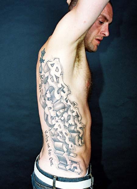 Grey ink graffiti tattoo on man side rib