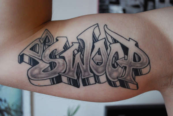 Grey ink graffiti tattoo on muscles