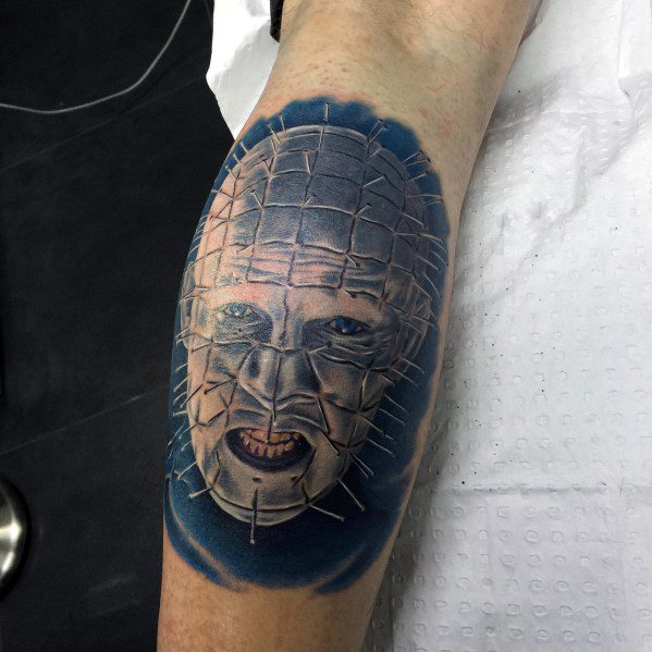 Guy with 3d hellraiser tattoo on leg calf