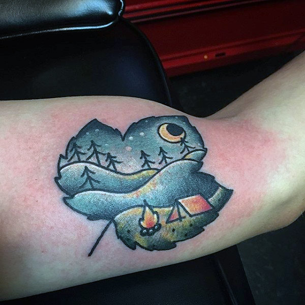 Guy with simple cartoon camping under moonlight maple lea bicep tattoo