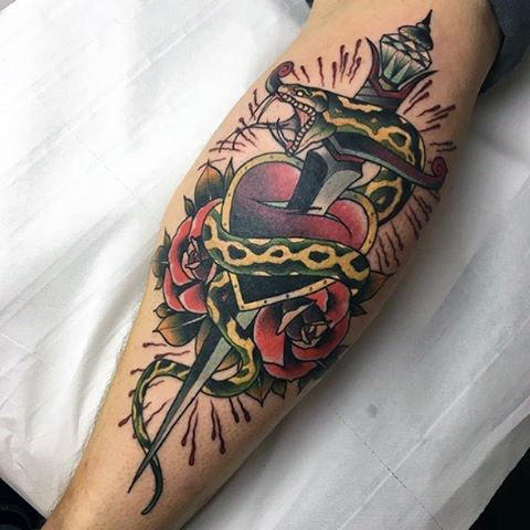 Guys forearms dagger heart and snake tattoo Guys forearms dagger heart and snake tattoo