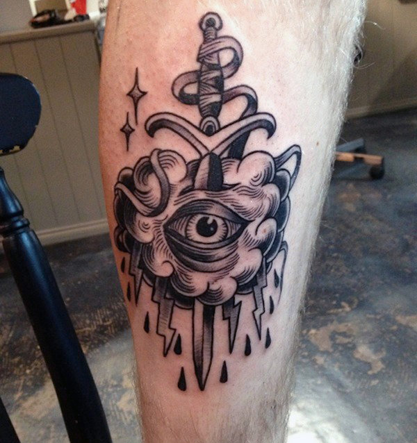 Guys lower legs dagger through eye tattoo