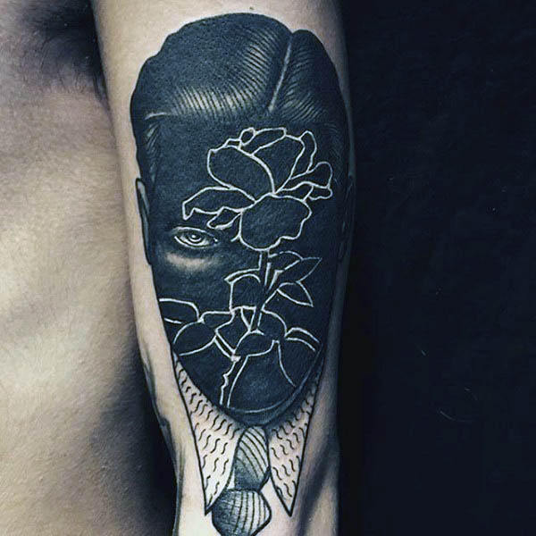 Guys negative space rose face tattoo design on upper arm