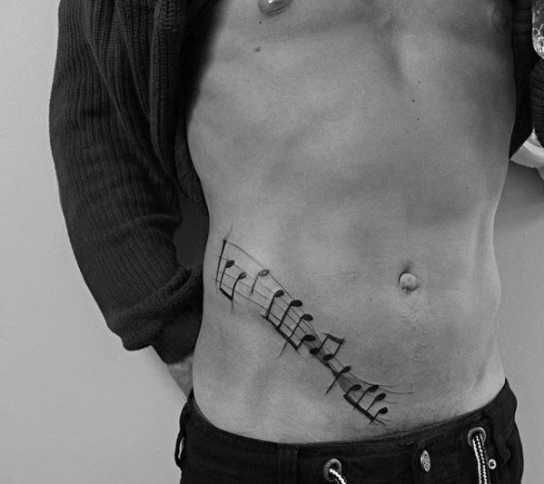 Lower chest ribs music staff guys tattoo Lower chest ribs music staff guys tattoo