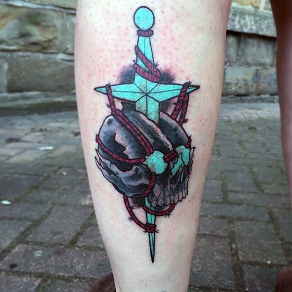Male calves blue dagger through skull tattoo inspiration