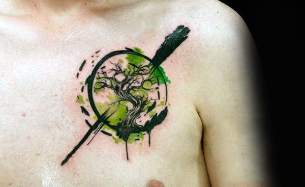 Male chest green watercolor tree in sphere tattoo