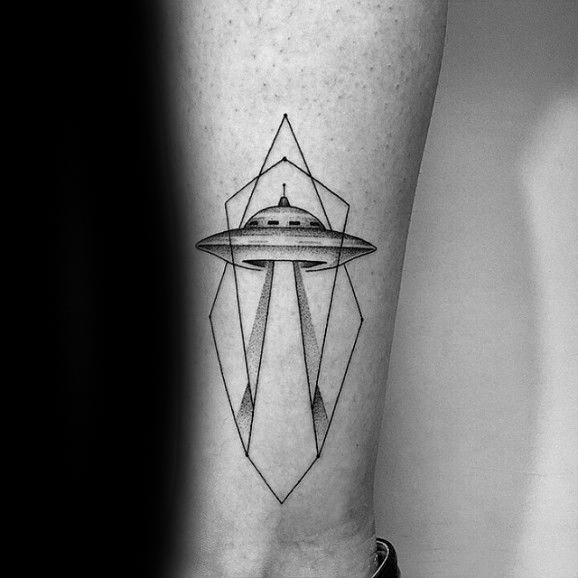 Male with geometric spaceship leg tattoo