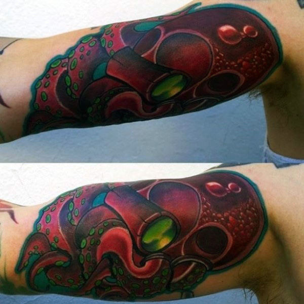 Man with bicep graffiti tattoo of red octopus