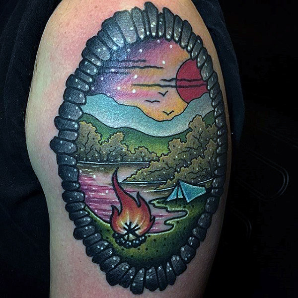 Man with bordered upper arm tattoo of campsite Man with bordered upper arm tattoo of campsite