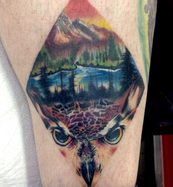 Man with diamond hawk and nature scene bright leg tattoo