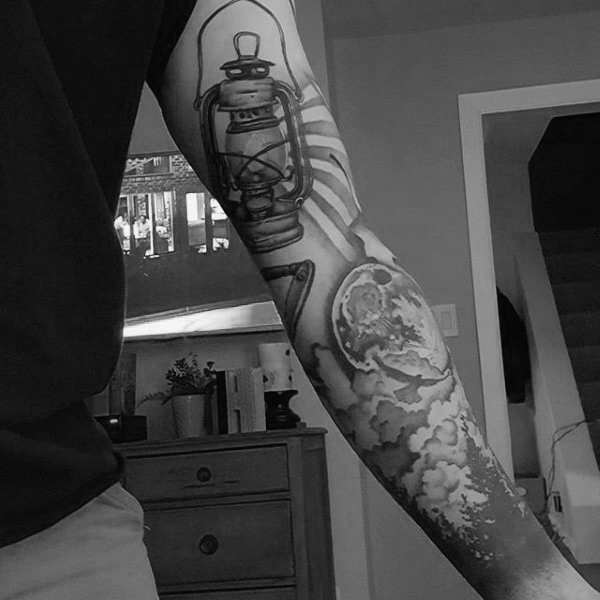 Man with forest and camp light tattoo full sleeve in modern style