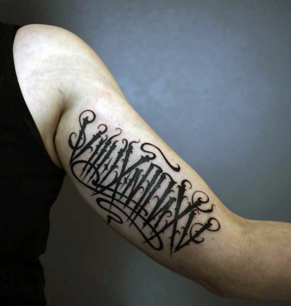 Man with inner arm black ink script modern tattoo