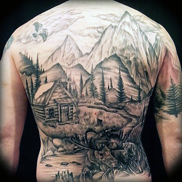 Man with shaded log cabin