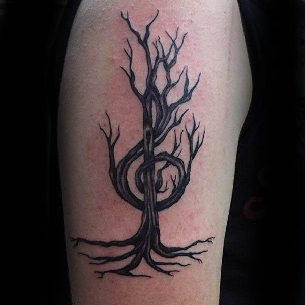 Men treble clef tree tattoos on upper arm