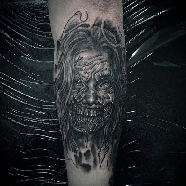 Mens black ink shaded female zombie tattoo on outer forearm Mens black ink shaded female zombie tattoo on outer forearm