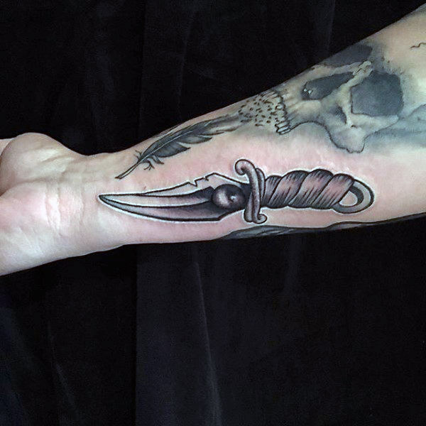 Metallic dagger male forearms
