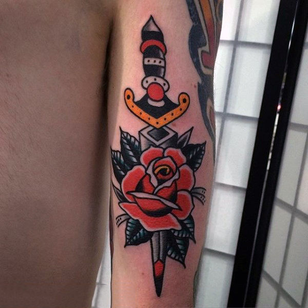 Red rose and dagger tattoo male forearms