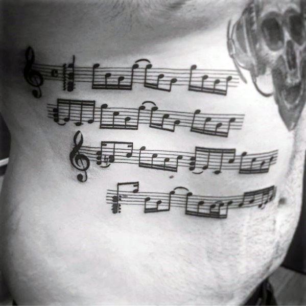 Rib cage side music staff mens tattoo ideas